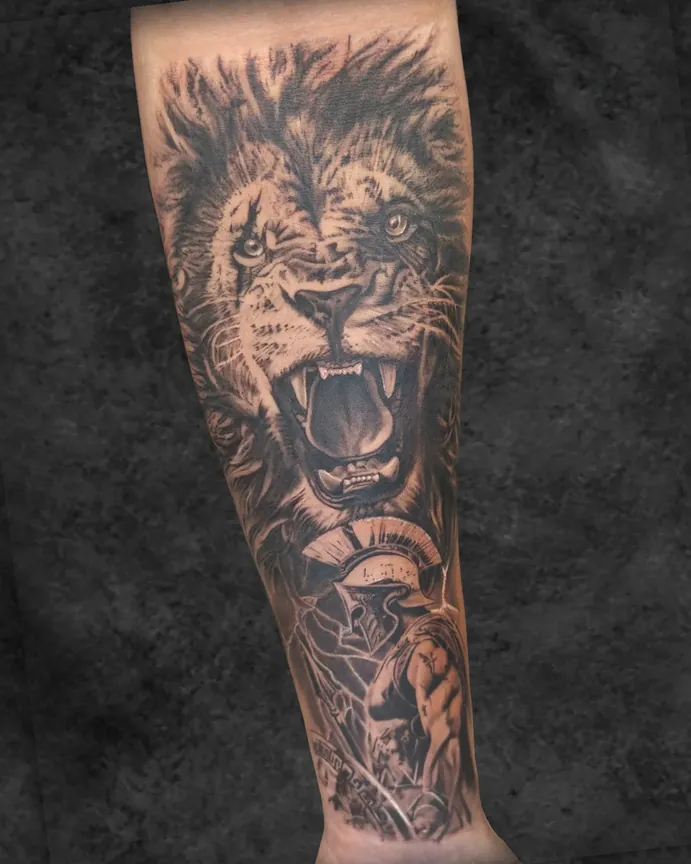 Lion and Spartan black and grey realism tattoo by Rebel Tattoos Gurgaon