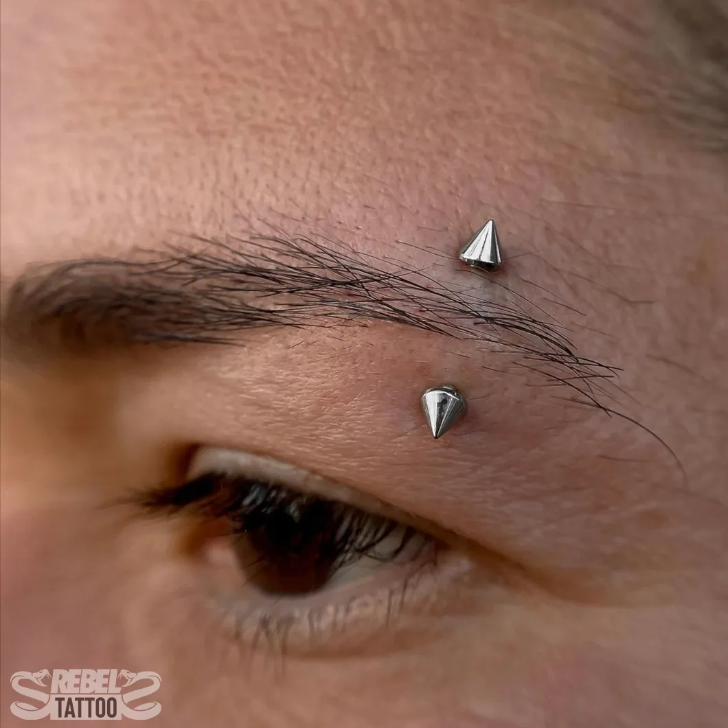 Twin spike eyebrow barbell piercing in implant grade titanium at Rebel Tattoos Gurgaon