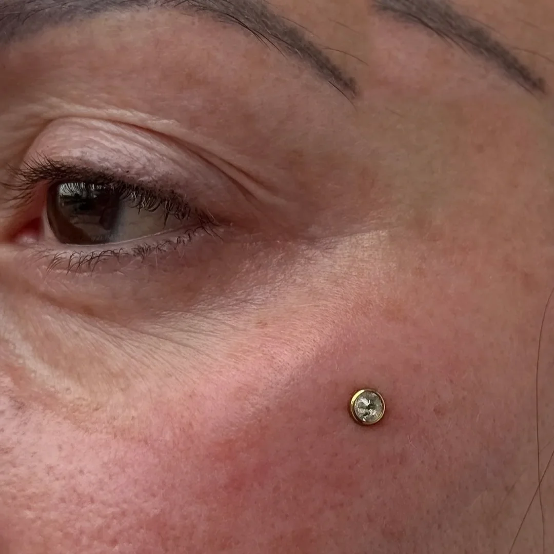 Cheekbone dermal piercing with implant grade titanium anchor, face piercing at Rebel Tattoos Gurgaon