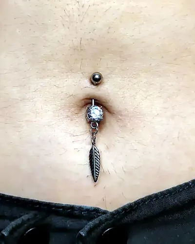 Navel piercing, feather dangle at Rebel Tattoos, Sector 67 Gurgaon