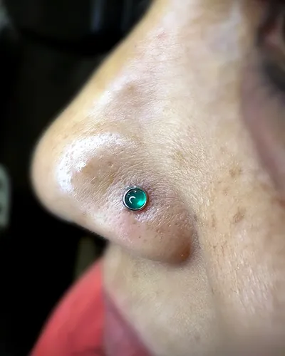 Nostril piercing, teal stone at Rebel Tattoos, Sector 67 Gurgaon