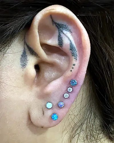 Stacked lobes piercing, opal blue at Rebel Tattoos, Sector 67 Gurgaon