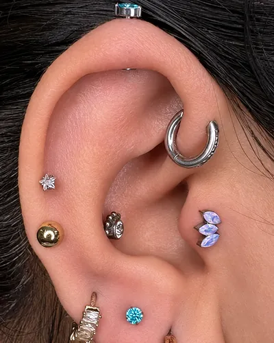 Curated ear with layered piercings in implant-grade titanium at Rebel Tattoos Gurgaon