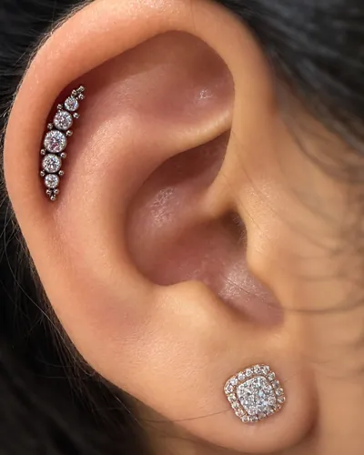 Helix piercing with a cubic zirconia climber in implant-grade titanium at Rebel Tattoos Gurgaon