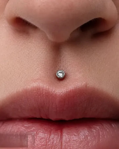 Medusa philtrum piercing with a crystal stud in implant-grade titanium at Rebel Tattoos Gurgaon