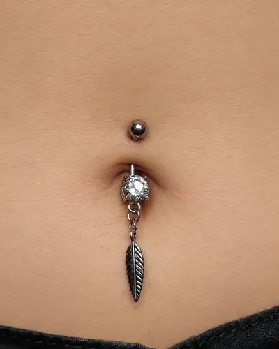Navel piercing, feather dangle at Rebel Tattoos, Sector 67 Gurgaon