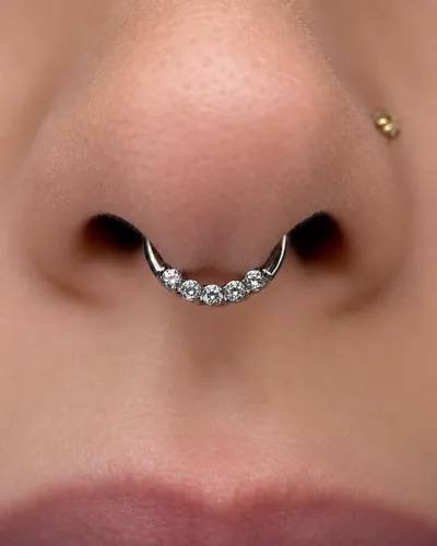 Septum piercing with a pave clicker in implant-grade titanium at Rebel Tattoos Gurgaon