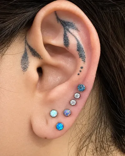Stacked lobes piercing, opal blue at Rebel Tattoos, Sector 67 Gurgaon