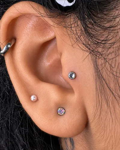 Tragus piercing with a single stud in implant-grade titanium at Rebel Tattoos Gurgaon