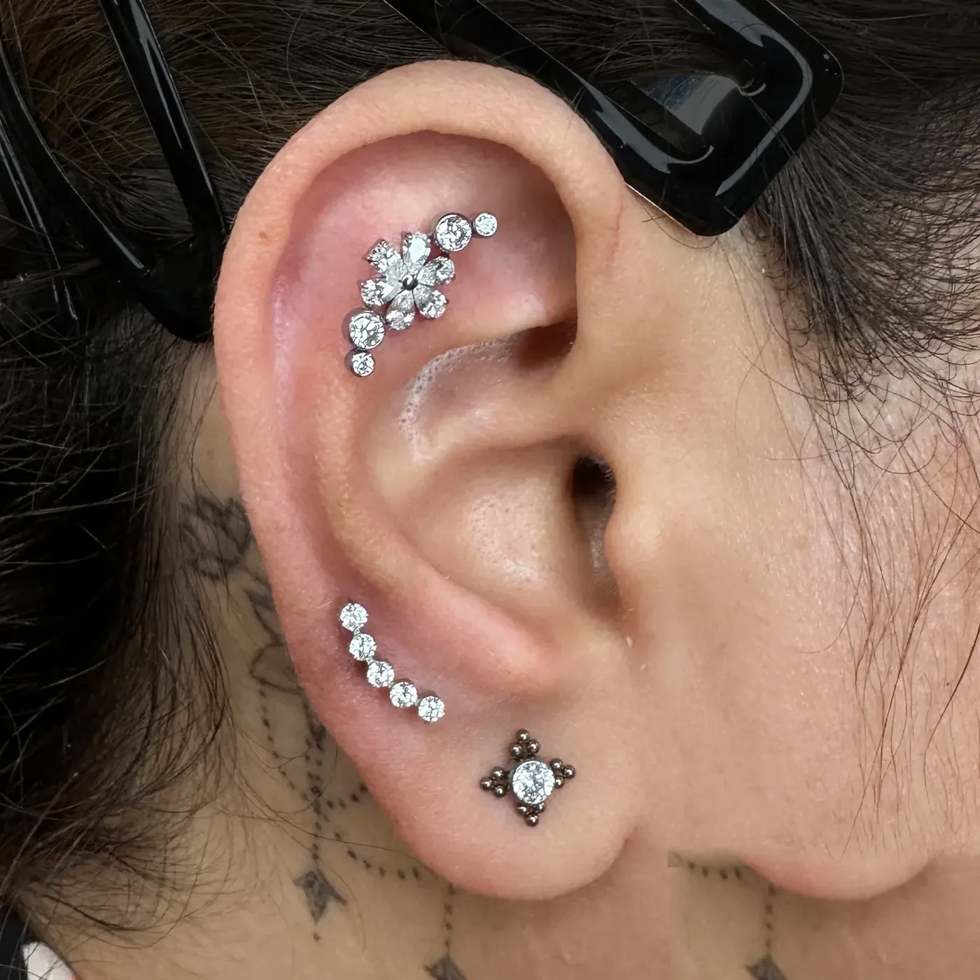 Helix cluster with CZ stones in implant grade titanium, ear piercing at Rebel Tattoos Gurgaon