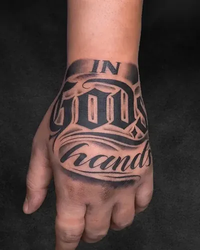 In God's Hands, lettering tattoo on the hand, black and grey, at Rebel Tattoos, Sector 67 Gurgaon