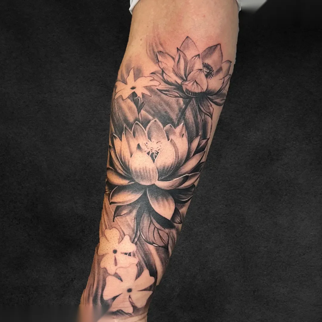 Lotus half sleeve botanical realism tattoo at Rebel Tattoos Gurgaon